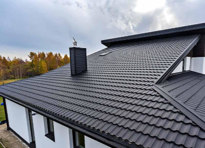 Two table top glass jars of succulents.